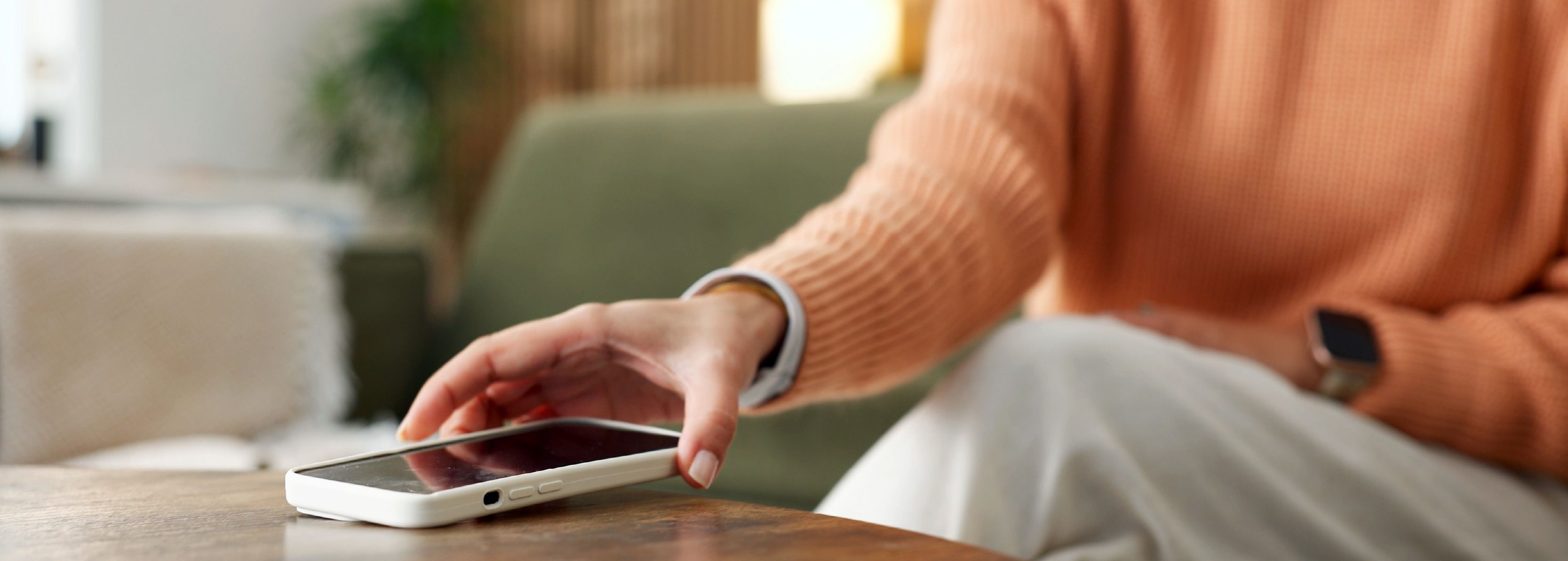 Woman reaching for her phone