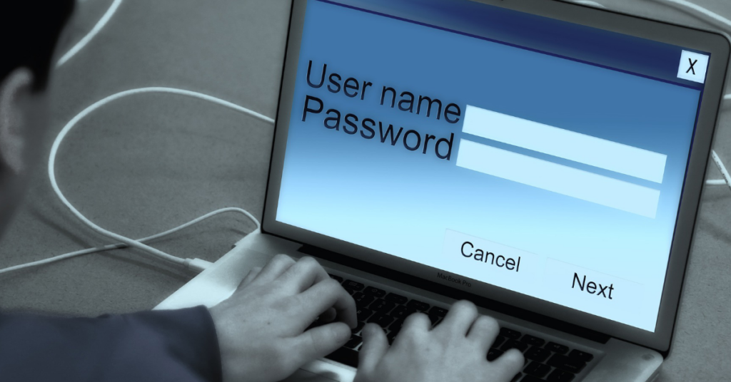 Person typing their username and password in on a screen