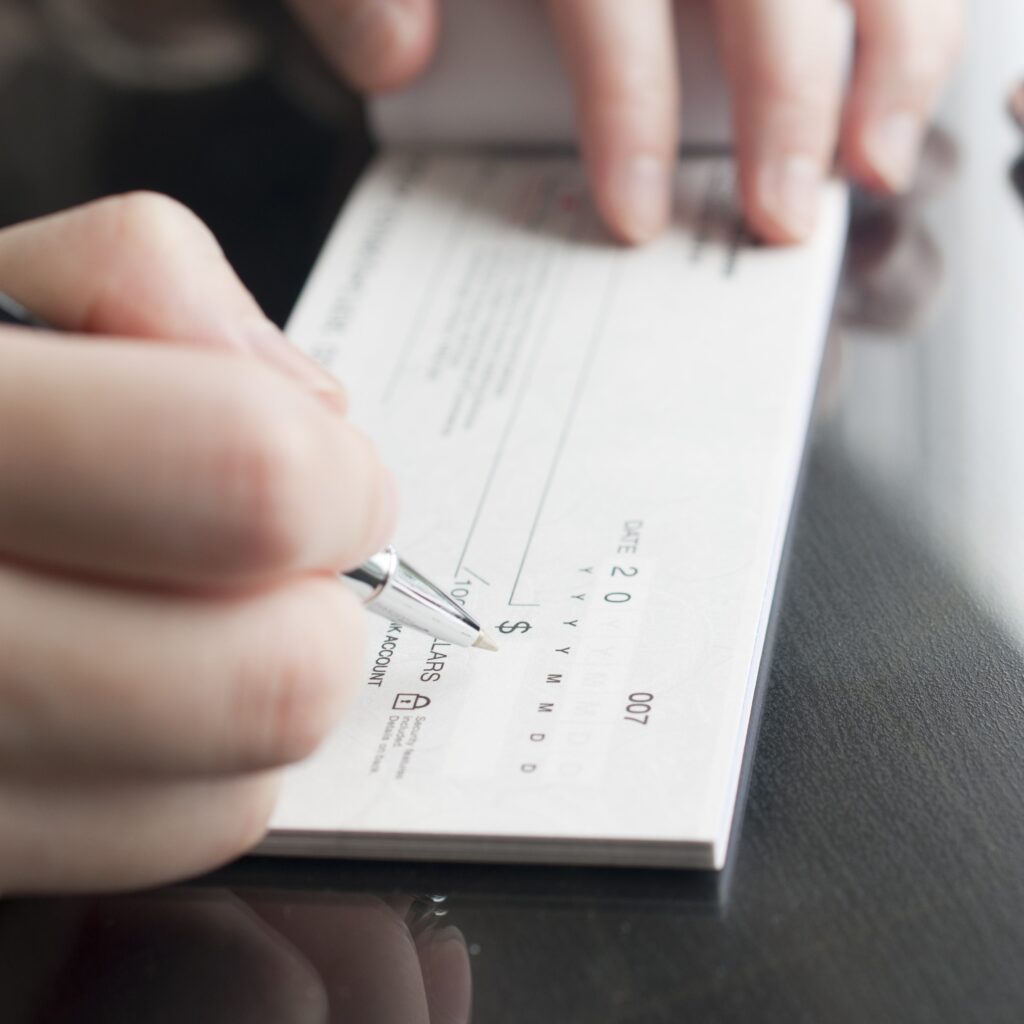 Person writing a check