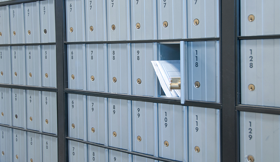 mail waiting in the u.s. grey/blue post office box