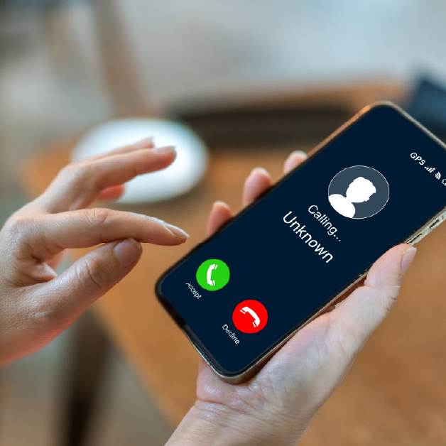 Woman considers whether to accept or decline a phone call from an unknown number