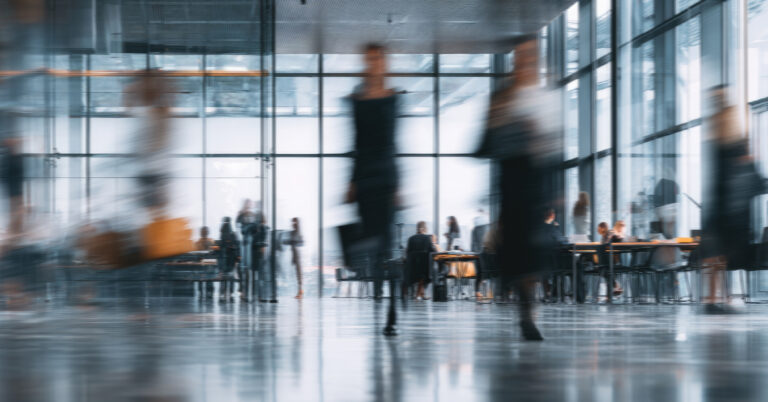 Blurred motion of people in an office