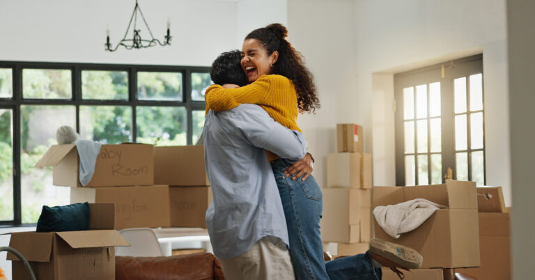 Happy couple in a house packed up for moving