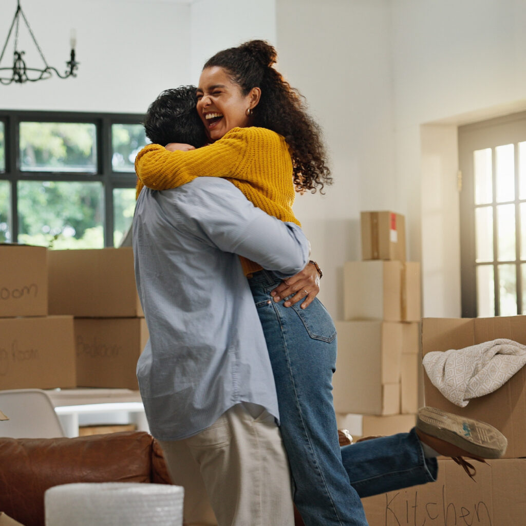 Happy couple in a house packed up for moving
